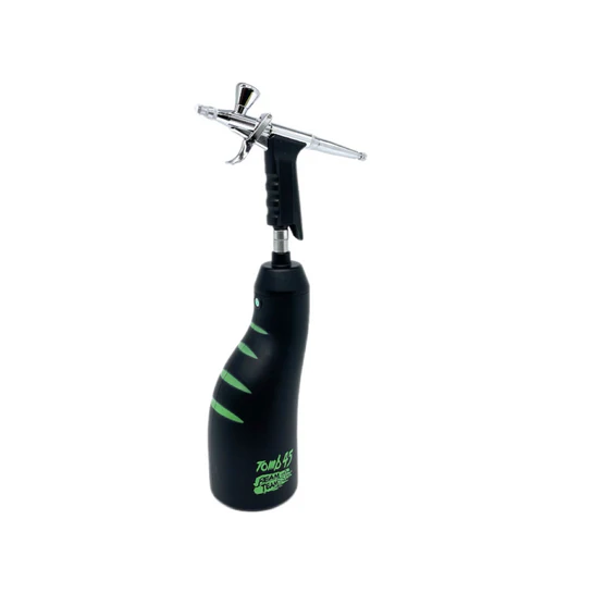 Black and green airbrush gun on a white background