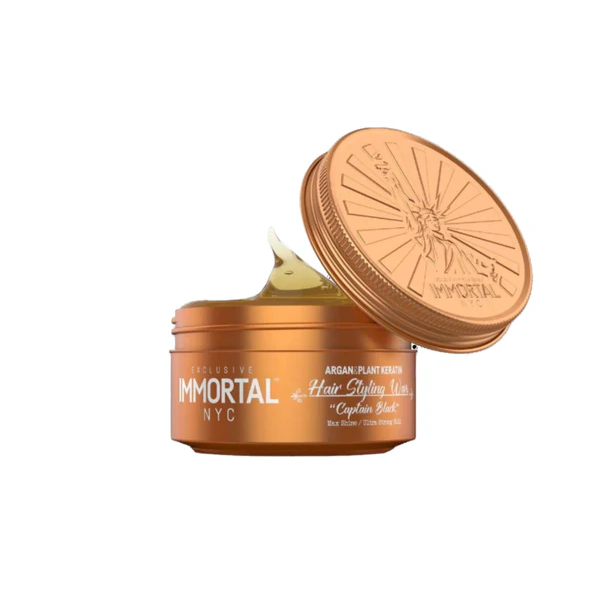 Open jar of Immortal NYC hair styling wax on a white background