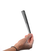 Hand holding a black comb against a white background
