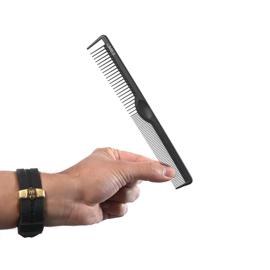 Hand holding a black comb on a white background