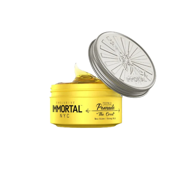 Yellow jar of Immortal NYC pomade with silver lid on a white background