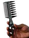 Black hair comb held by a hand on a white background