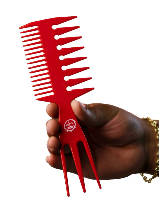 Red comb held by a hand on a white background