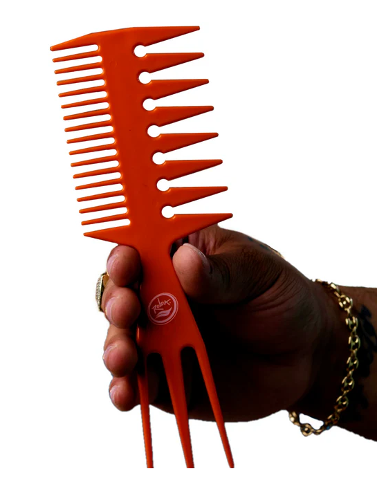 Hand holding an orange hair comb against a white background