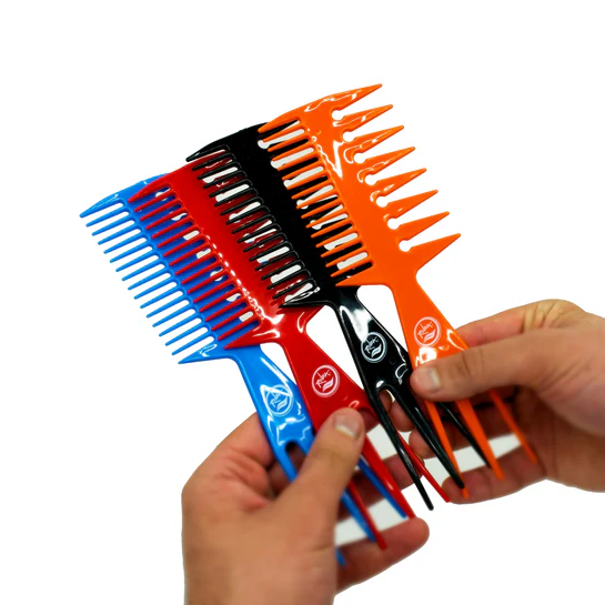 Set of colorful hair combs held by a hand on a white background