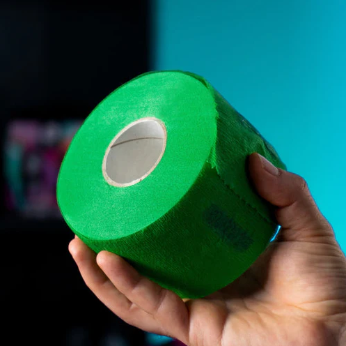 Hand holding a roll of green Rolda neck strips against a blue background
