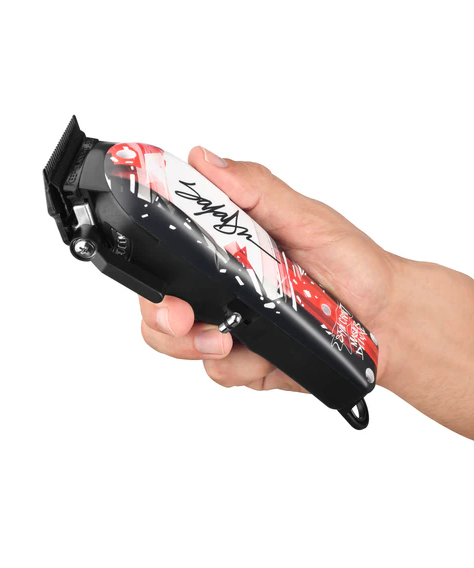 Hand holding a hair clipper with a white background