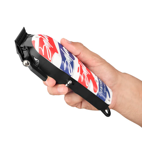 Hand holding a hair clipper with a red, white, and blue design on a white background