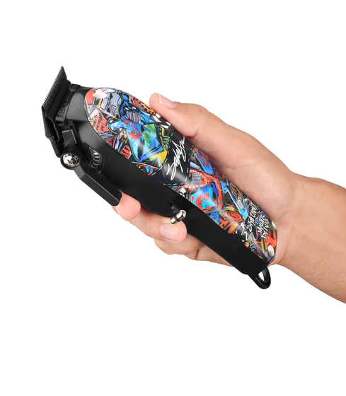 Hand holding a colorful hair clipper against a white background