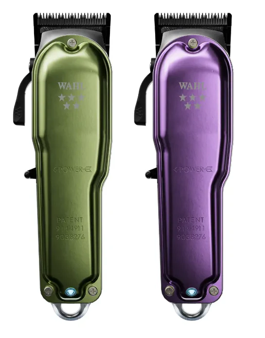 Two Wahl legend+ hair clippers, one green and one purple, on a white background.