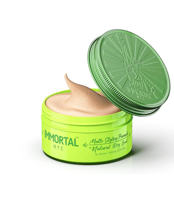 Green jar of 'Immortal NYC' hair product with a green lid on a white background