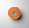 Orange roll of 'L3VEL3' neck strips on a light gray background