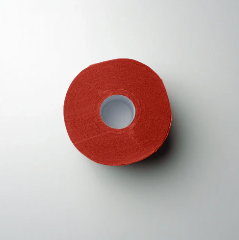 Red roll of 'L3VEL3' neck strips on a light gray background