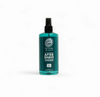 Green bottle of after-shave cologne on a white background