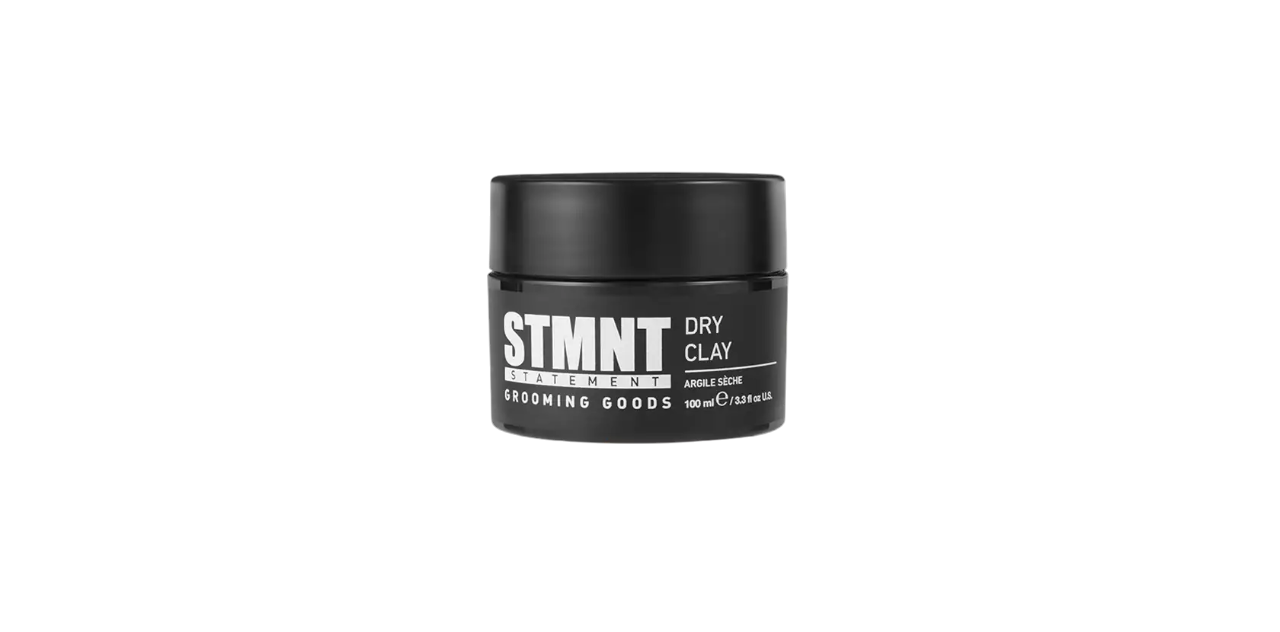 Black jar of STMNT grooming goods dry clay product on a white background