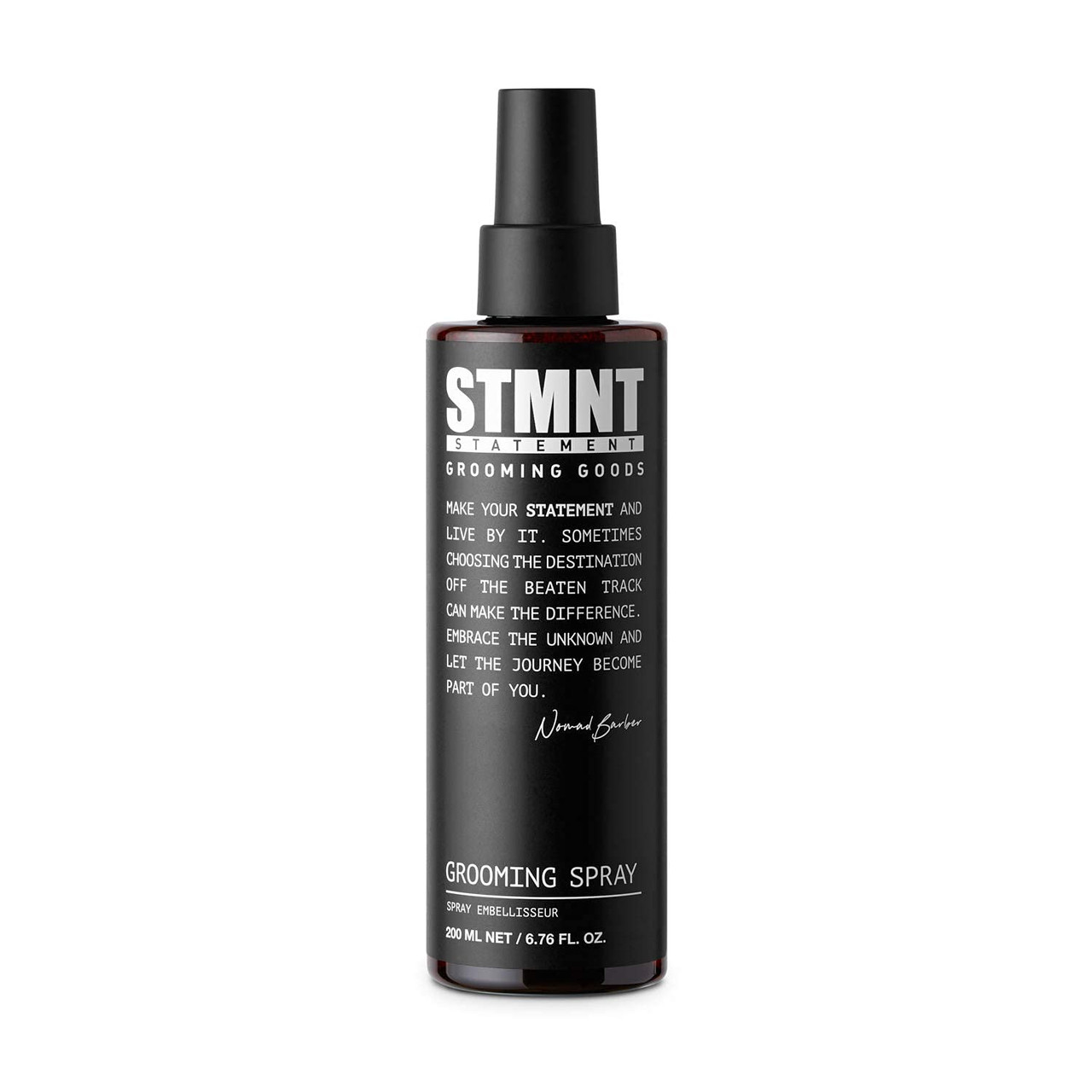 Black grooming spray bottle with STMNT branding on a white background