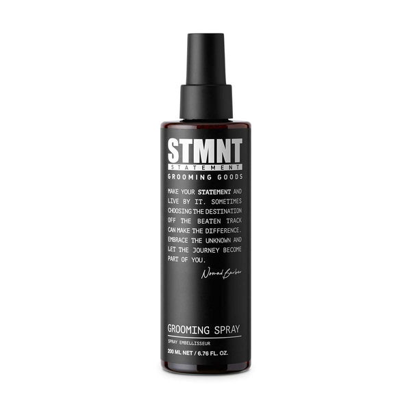 Black grooming spray bottle with STMNT branding on a white background