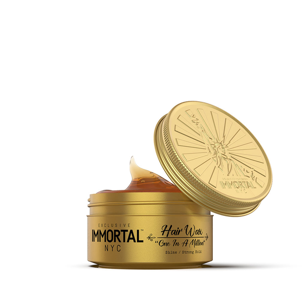Gold jar of Immortal NYC hair wax with open lid on a white background
