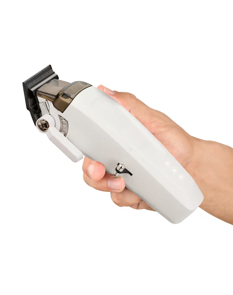 Hand holding a white hair clipper against a white background