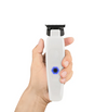 Hand holding a white grooming tool with a blue light on a white background
