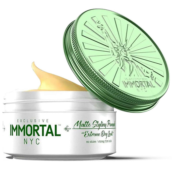 Open jar of Immortal NYC matte styling pomade with green lid on a white background